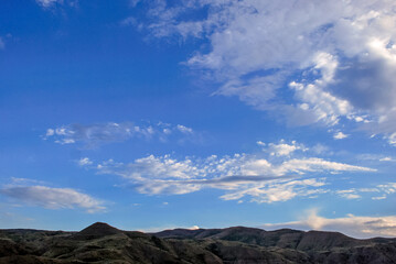 Rolling hills and expansive sky at sunset over serene landscape