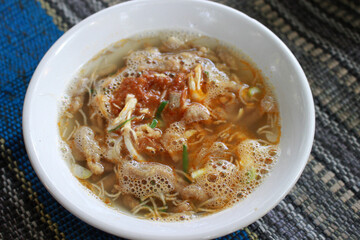 a bowl of chicken soto tauto