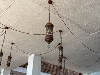 Elegant hanging lanterns with intricate designs illuminating a cozy space.