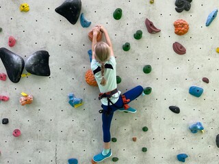 Girl on Colorful Climbing Wall