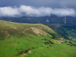 Idyllic mountain scenery surrounded by clouds