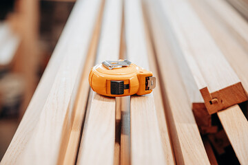 Orange Tape Measure on Wooden Slats in Workshop