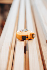 Orange Tape Measure on Wooden Slats in Workshop