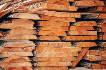 Rough-Cut Timber Planks Stacked with Bark Edges