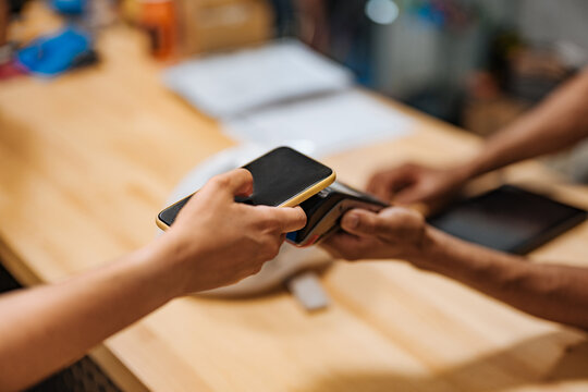Customer paying with smartphone in a bicycle shop