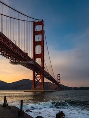 Golden Gate Bridge view from Fort Point with waves crashing on the shore