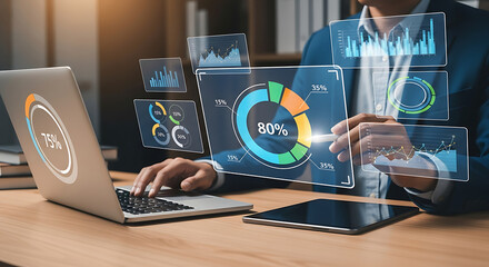 Businessman analyzing digital data and charts on futuristic interface with laptop