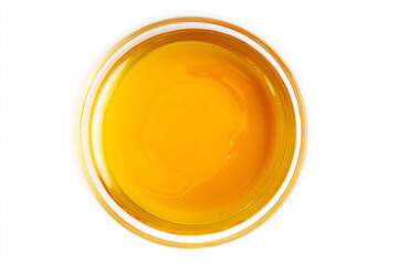 a bowl of orange juice on a white surface