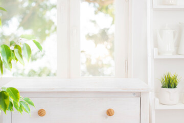 Naklejka na ściany i meble Table top of bleached wooden cabinet for product display montage on blurred kitchen window background