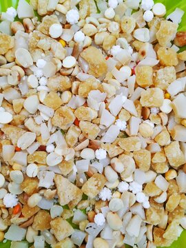 Beautiful Pongal Traditional Raw Mixtures of Ellu Bella in a Green Plate isolated on white Background