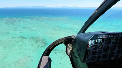 Helicopter flying over great barrier reef, turquoise ocean water, luxury travel experience, Queensland Australia