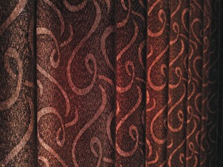 Abstract Brown Curtain with Swirls Textured Fabric in Warm Light Interior Design Element.