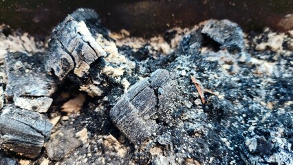 the remains of burning using charcoal, some of which has turned to ash