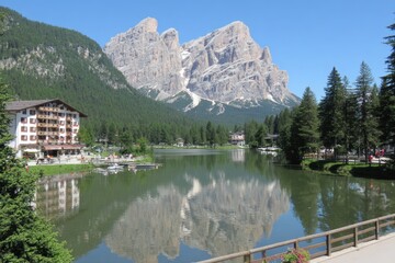 Fototapeta premium Alpine lake reflecting majestic peaks