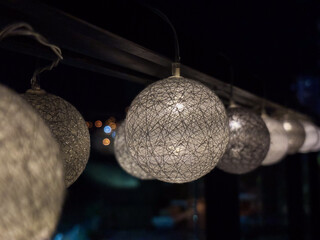 Row of Decorative String Light Balls in the Dark