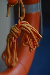 CloseUp of Orange Lifebuoy Rope Safety Texture and Nautical Detail.