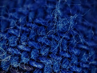Intricate Macro View of Blue Fabric Fibers and Texture.
