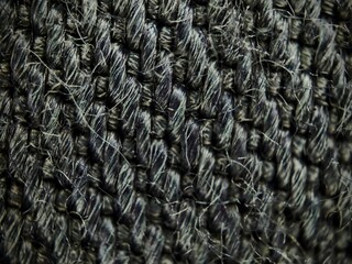 Intricate Macro View of Woven Gray Fabric Texture with Loose Fibers.