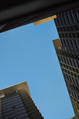 Skyscrapers Framing Azure Sky Modern Architecture Perspective Urban Geometry Clear Day.