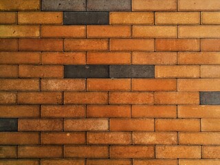 Textured Brick Wall with Earthy Tones and Dark Accents Architectural Detail.