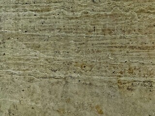 Textured Travertine Stone Surface with Horizontal Veins and Subtle Green Tones.