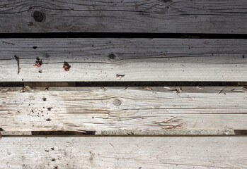 Old worn pallet creatively reused as outdoor furniture with plant remains