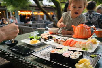 Fresh sushi selection featuring salmon, tuna and eel rolls, captured in authentic Japanese...