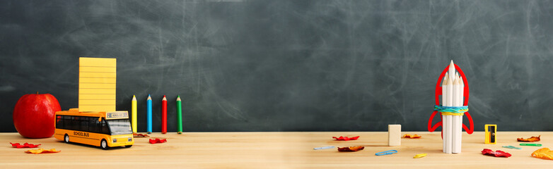 Back to school concept over classroom blackboard. Top view