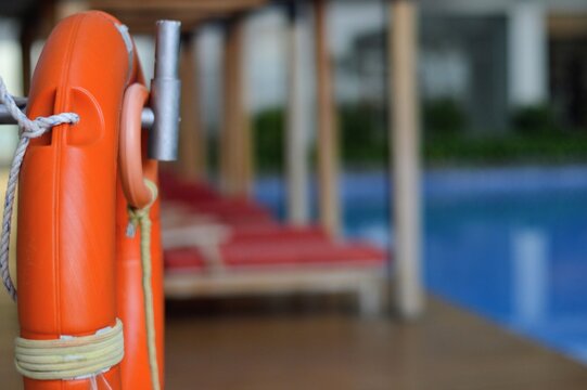 Vibrant Orange Life Preserver Ring by Poolside Safety and Serenity.
