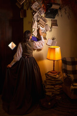 beautiful woman scientist in retro style examines books with a magnifying glass