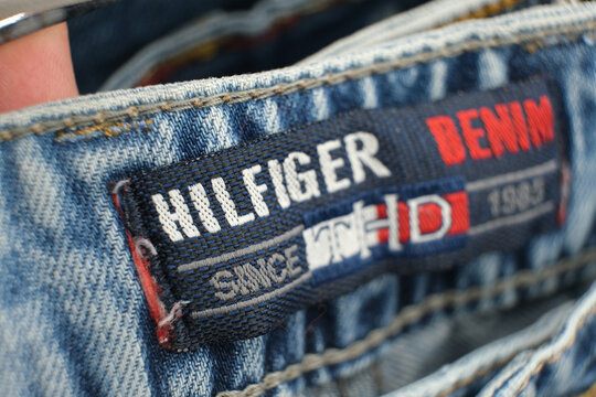 Tommy Hilfiger brand tag on stylish blue denim jeans. Contemporary fashion, retail, and consumer shopping. Editorial image highlighting apparel trends. Moscow, Russia, July 2, 2025
