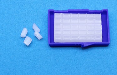 Orthodontic Wax for Braces on Blue Background &ndash; Dental Care Concept