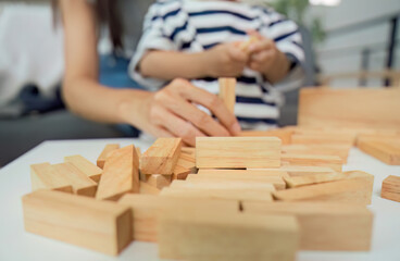 Creative Play. Child and parent engaging with wooden blocks for developmental learning.
