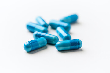 Amino acids capsules on bright background. Soft focus. Close up. Copy space.	