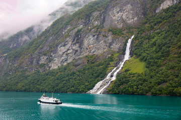 Tourism vacation and travel. Mountains, Geiranger fjord and Frieren ( Friaren ) waterfall in Norway...