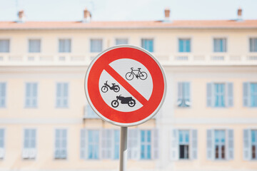 No bicycles or motorcycles allowed near the historic building in the city during a sunny day