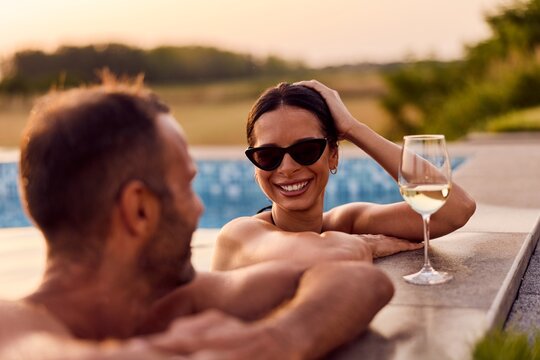 Happy Couple Relaxing By the Summer Poolside with White Wine - Powered by Adobe