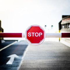 Barrier Gate with Red Stop Sign Blocking Road Access