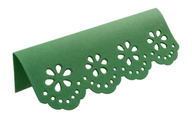 Green paper with intricate floral cutout design, folded over in a decorative style on transparent background.