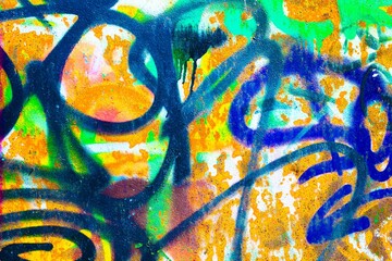 Graffiti art with neon green, blue, orange on textured wall. 80s, grunge street style, vibrant colors, abstract patterns. Urban murals, creative backgrounds, modern digital art projects.