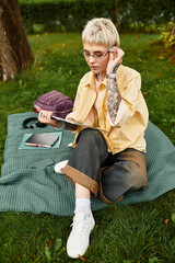 Stylish young woman enjoying a moment of creativity in a peaceful park environment