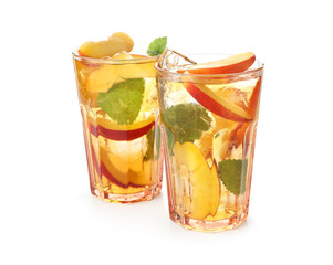 Refreshing iced peach tea in glasses isolated on white