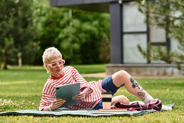 Young stylish woman enjoying a leisurely afternoon reading in a serene park setting
