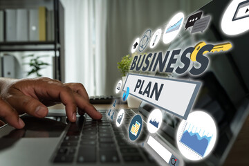 Business plan concept represented through digital icons and charts as a person types on a laptop in...
