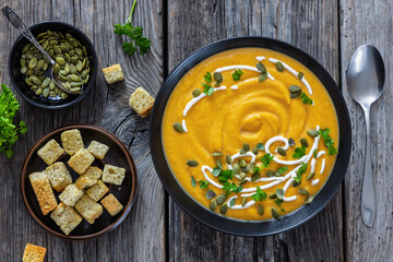 roasted pumpkin puree soup in a black bowl