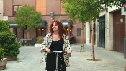 Young woman riding electric scooter in city center