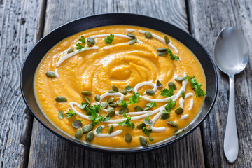 roasted pumpkin puree soup in a black bowl