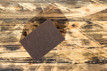wooden board made of pine planks for polishing with sandpaper on the construction site, close up