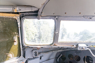 Vintage aircraft cabin interior, likely a bus model White ceiling contrasting worn, possibly dirty...