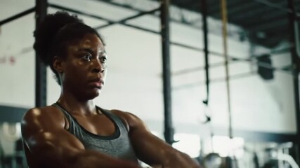Focused athlete powerfully swings kettlebell during intense gym workout session - Powered by Adobe